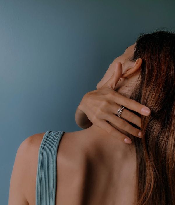 Person stretching gently in a calm, modern space.